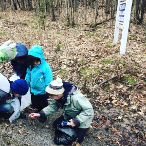 kids checking out something on the forest floor